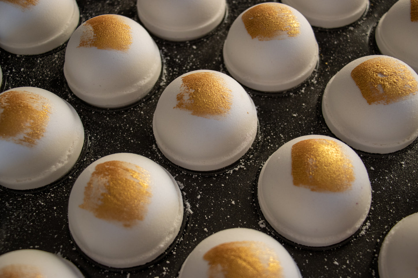 white bath bomb with gold brush stroke