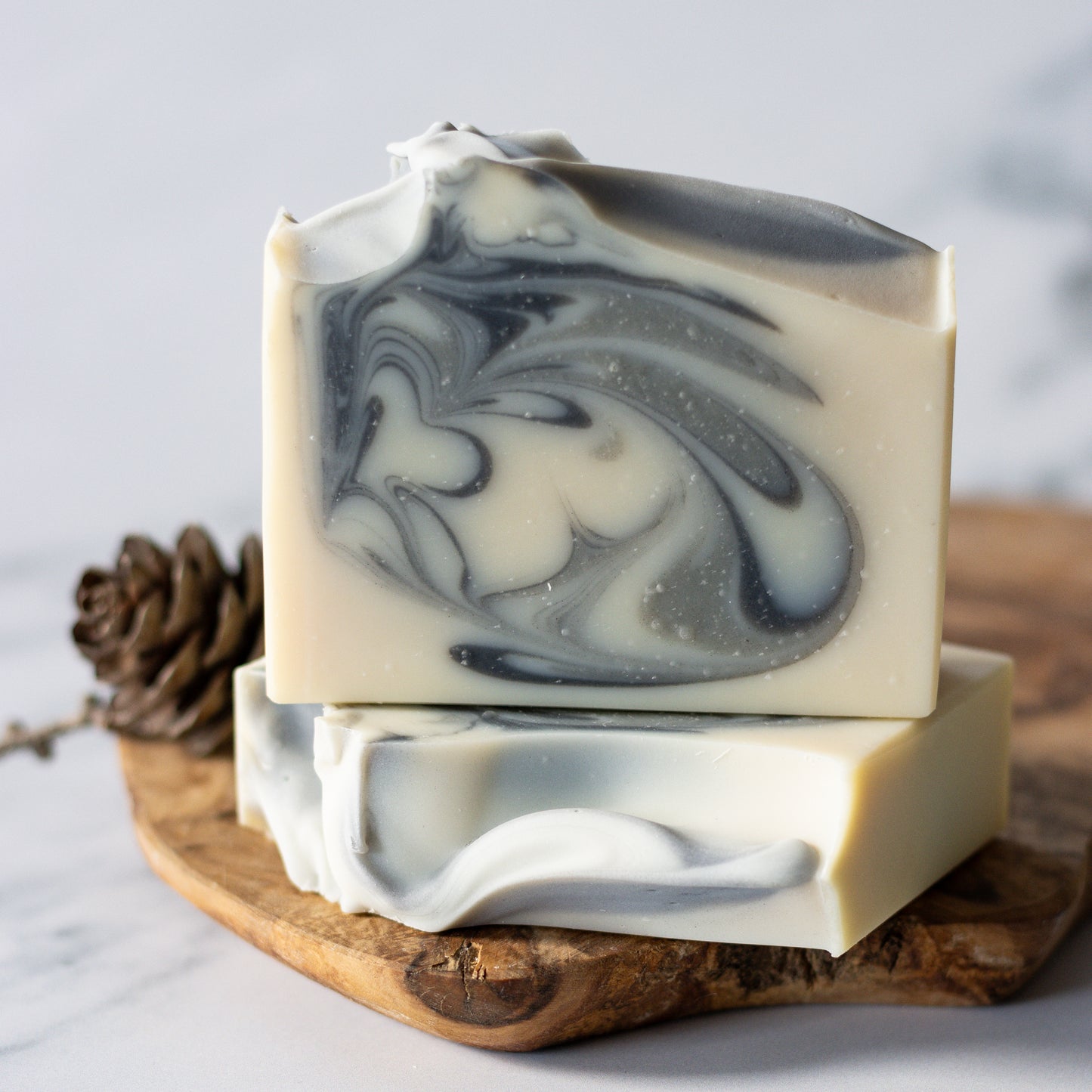 oat milk bar soap with charcoal and glacial clay swirl cedarwood, bergamot, and fir needle essential oils