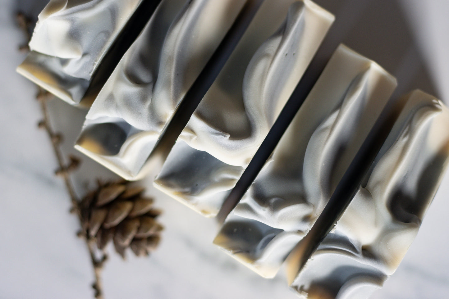 oat milk bar soap with charcoal and glacial clay swirl cedarwood, bergamot, and fir needle essential oils