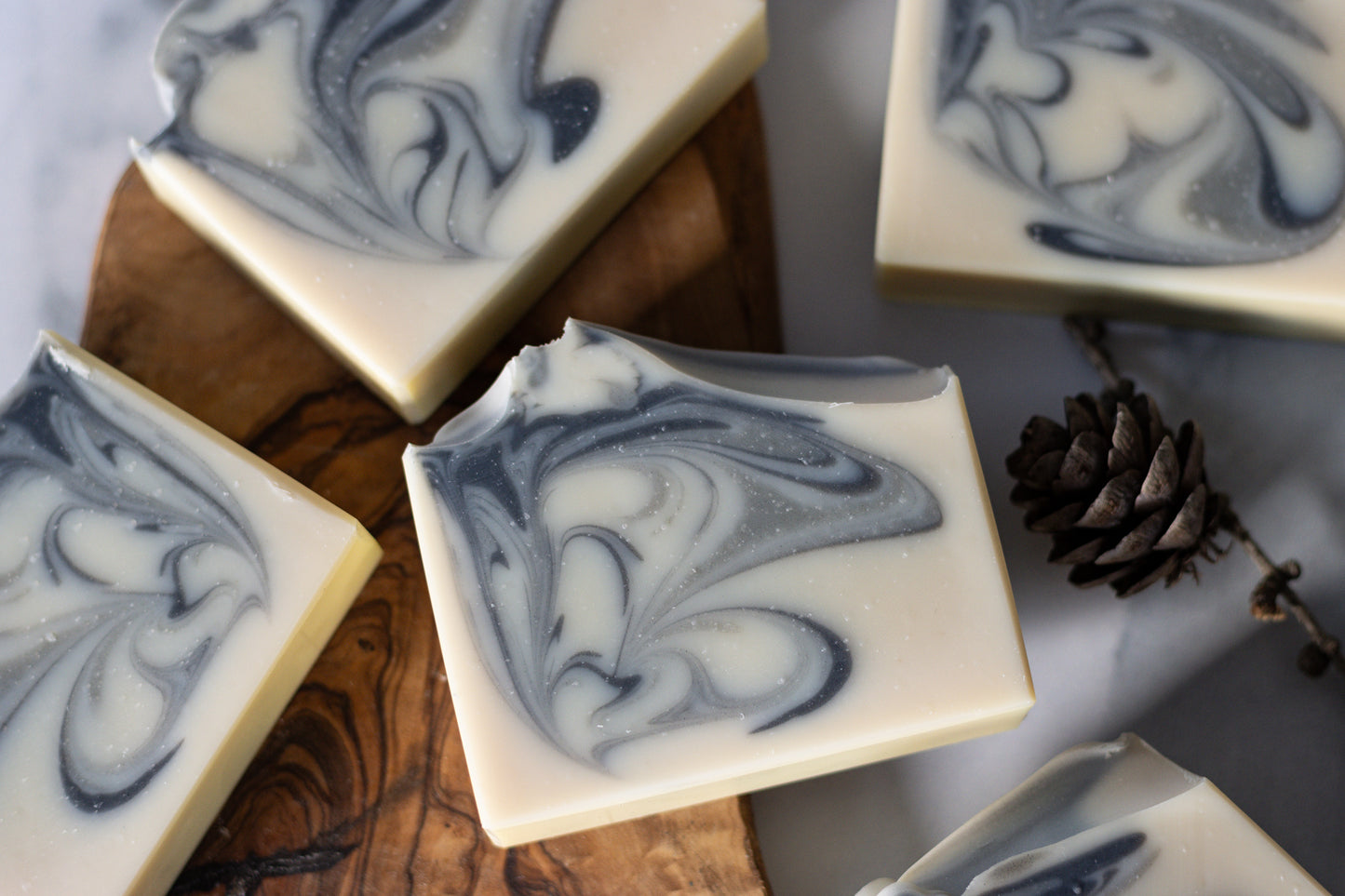 oat milk bar soap with charcoal and glacial clay swirl cedarwood, bergamot, and fir needle essential oils