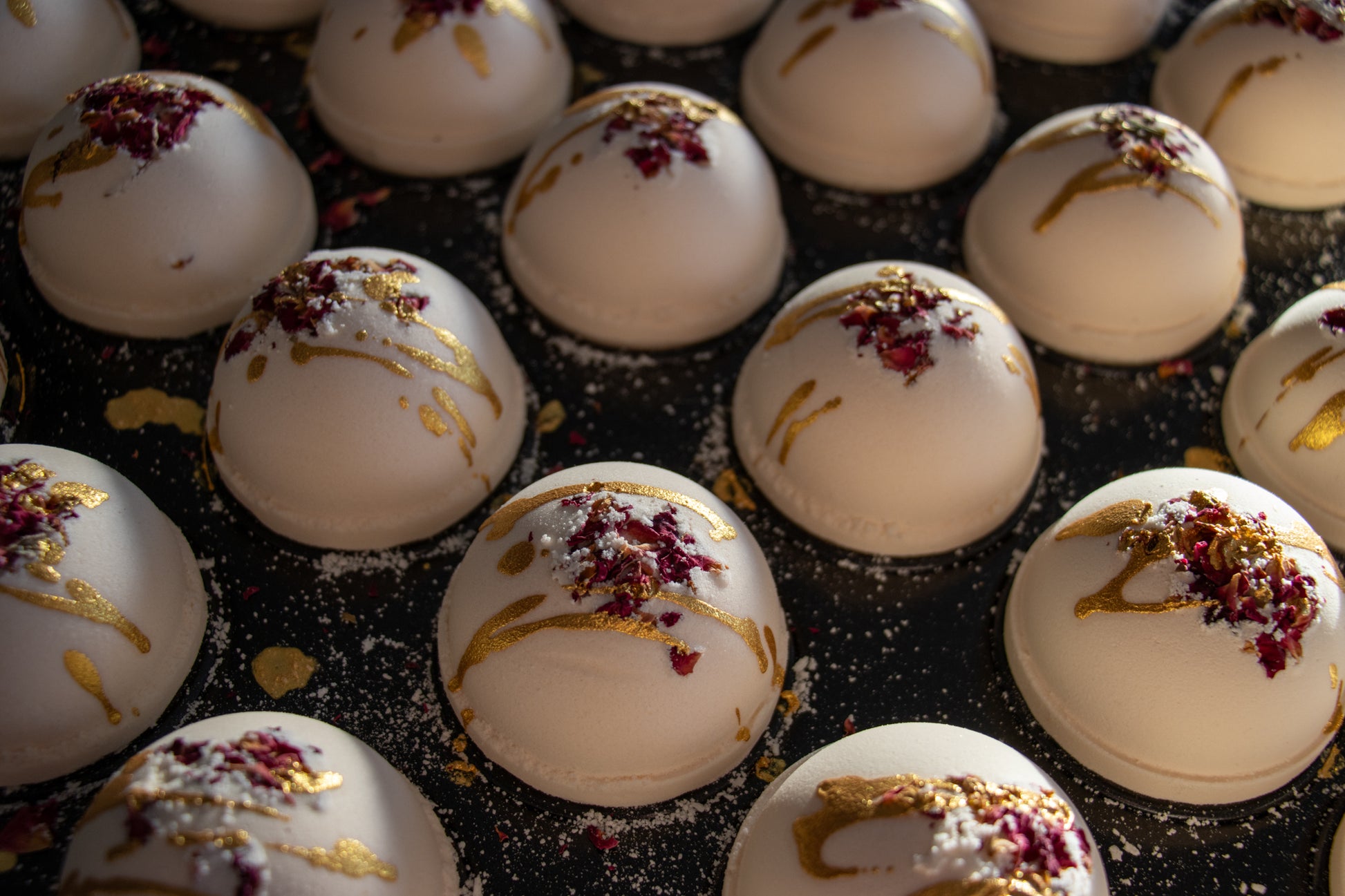 bath bomb with rose petals and gold mica drizzle