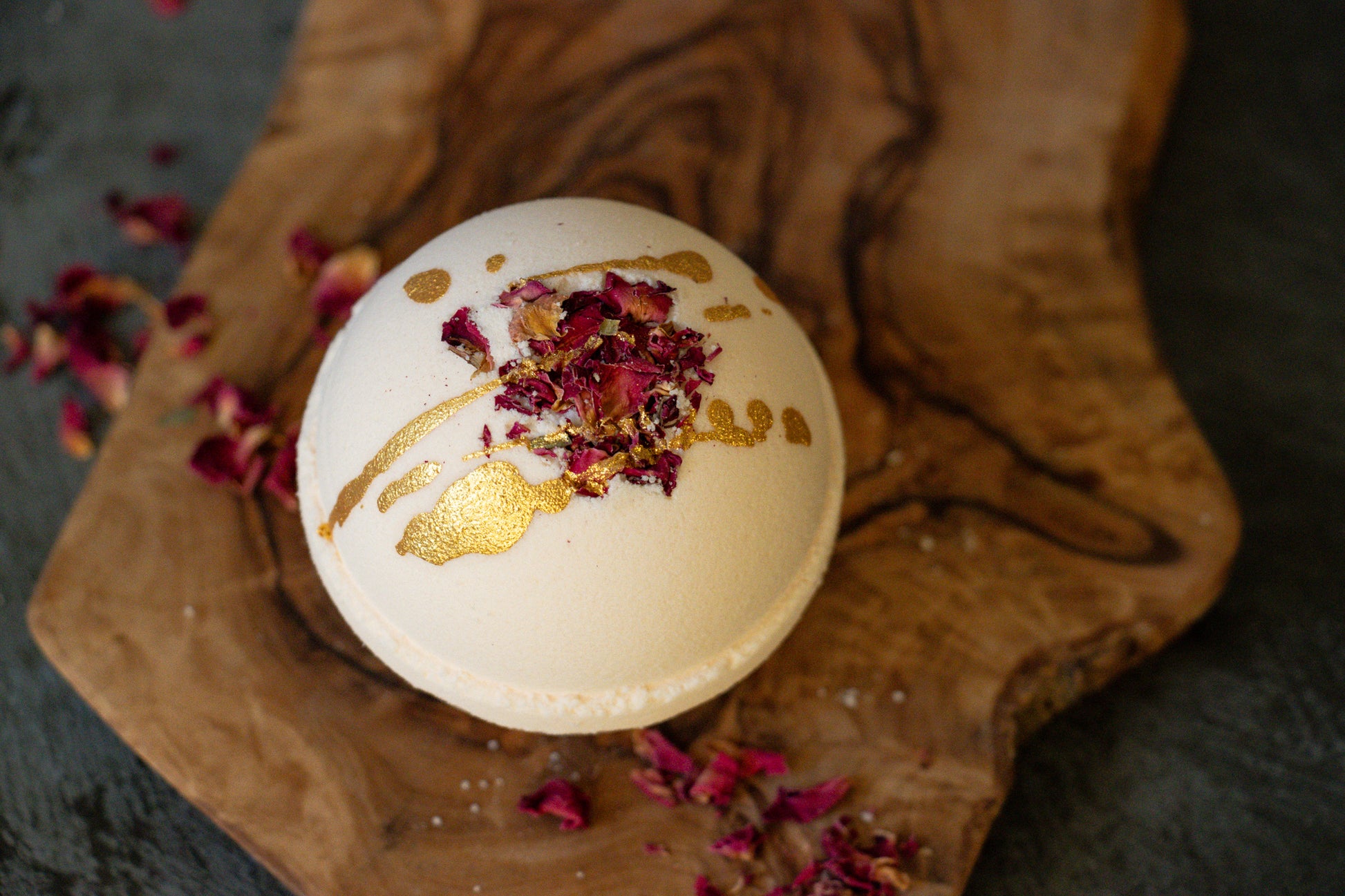 bath bomb with rose petals and gold mica drizzle