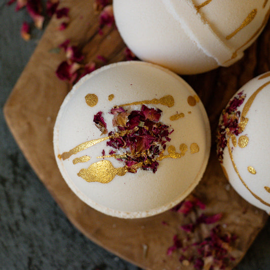 bath bomb with rose petals and gold mica drizzle