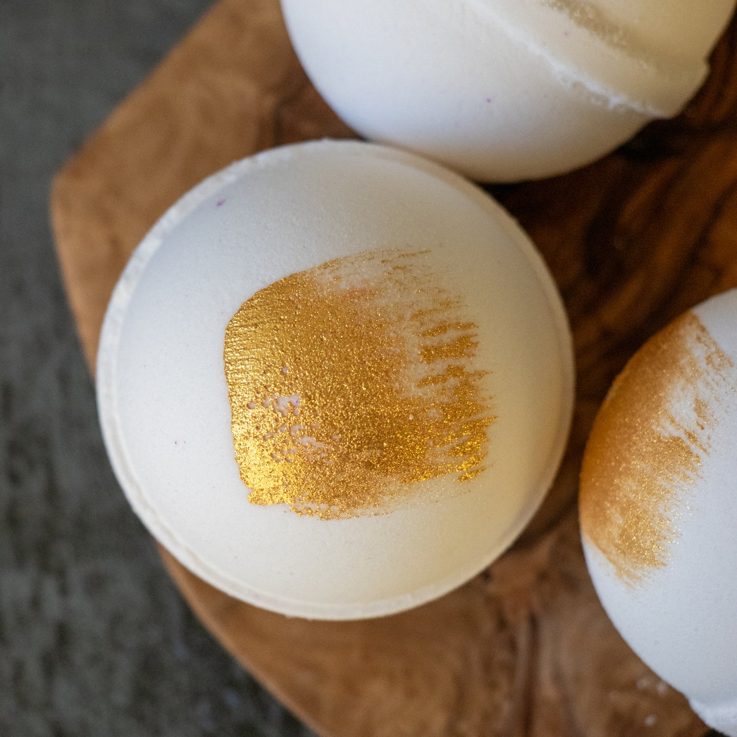 white bath bomb with gold brush stroke