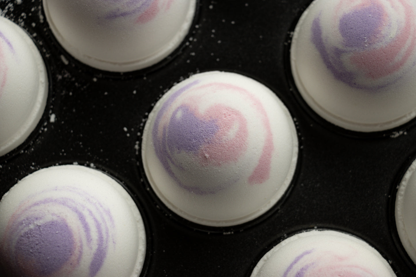 white bath bomb with purple & pink swirl